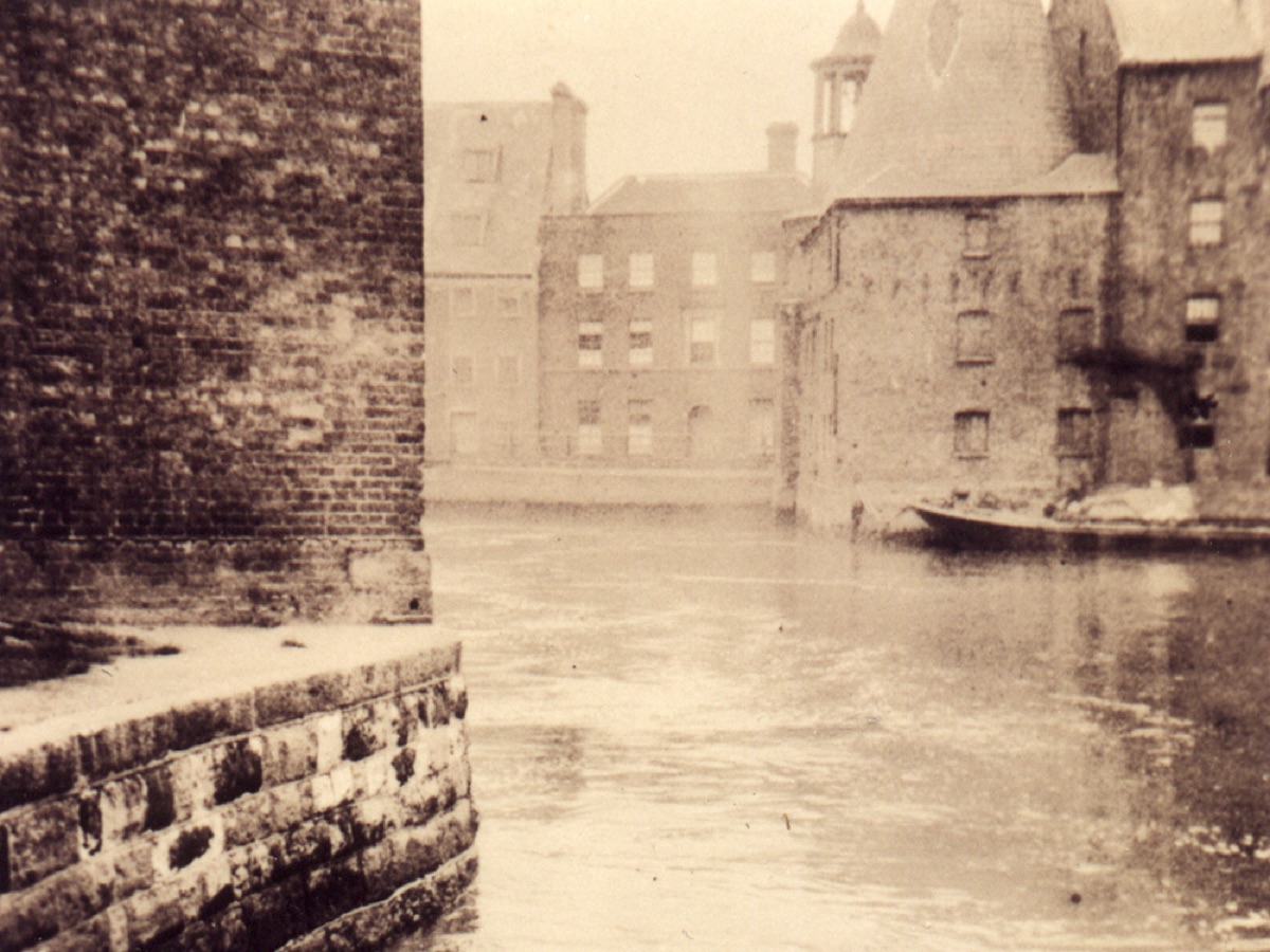 A 1930s photograph of the mills seen across the water.