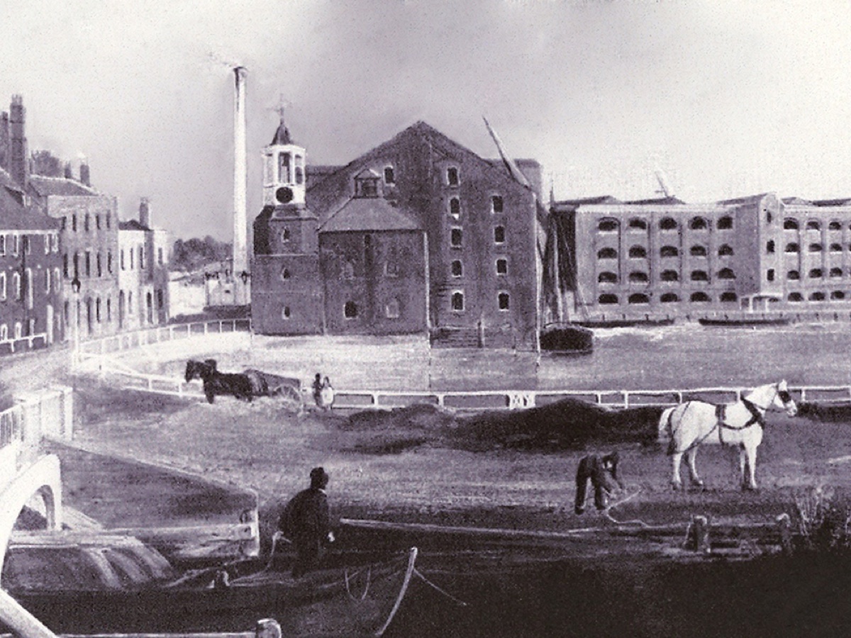 A historic print of Three Mills with a horse and cart and boats on the water.