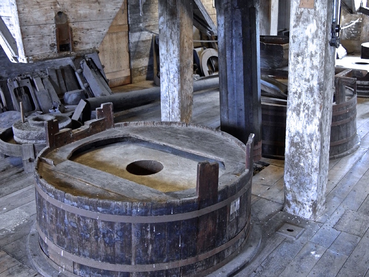 Close-up of a wooden grain tun with its iron bands inside the mill.